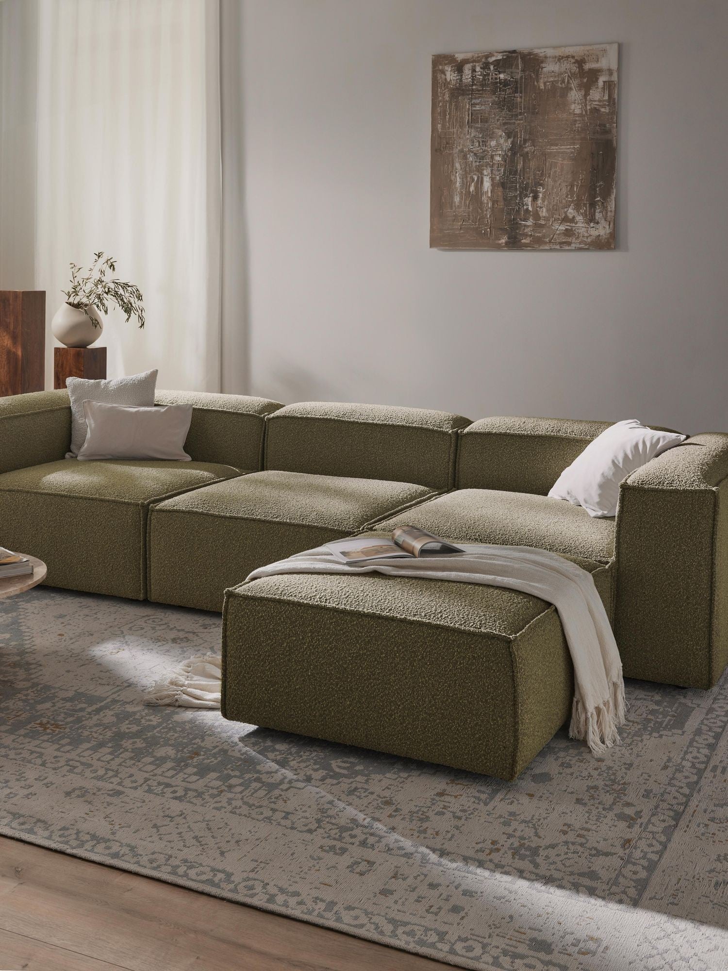 Canapé modulable 4 places en tissu bouclé avec pouf Frida