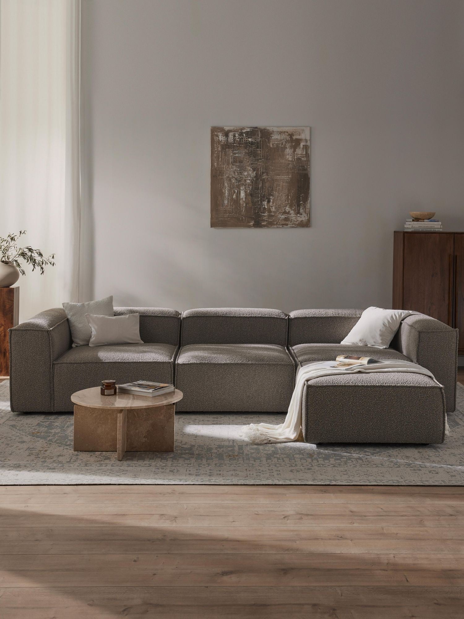 Canapé modulable 4 places en tissu bouclé avec pouf Frida