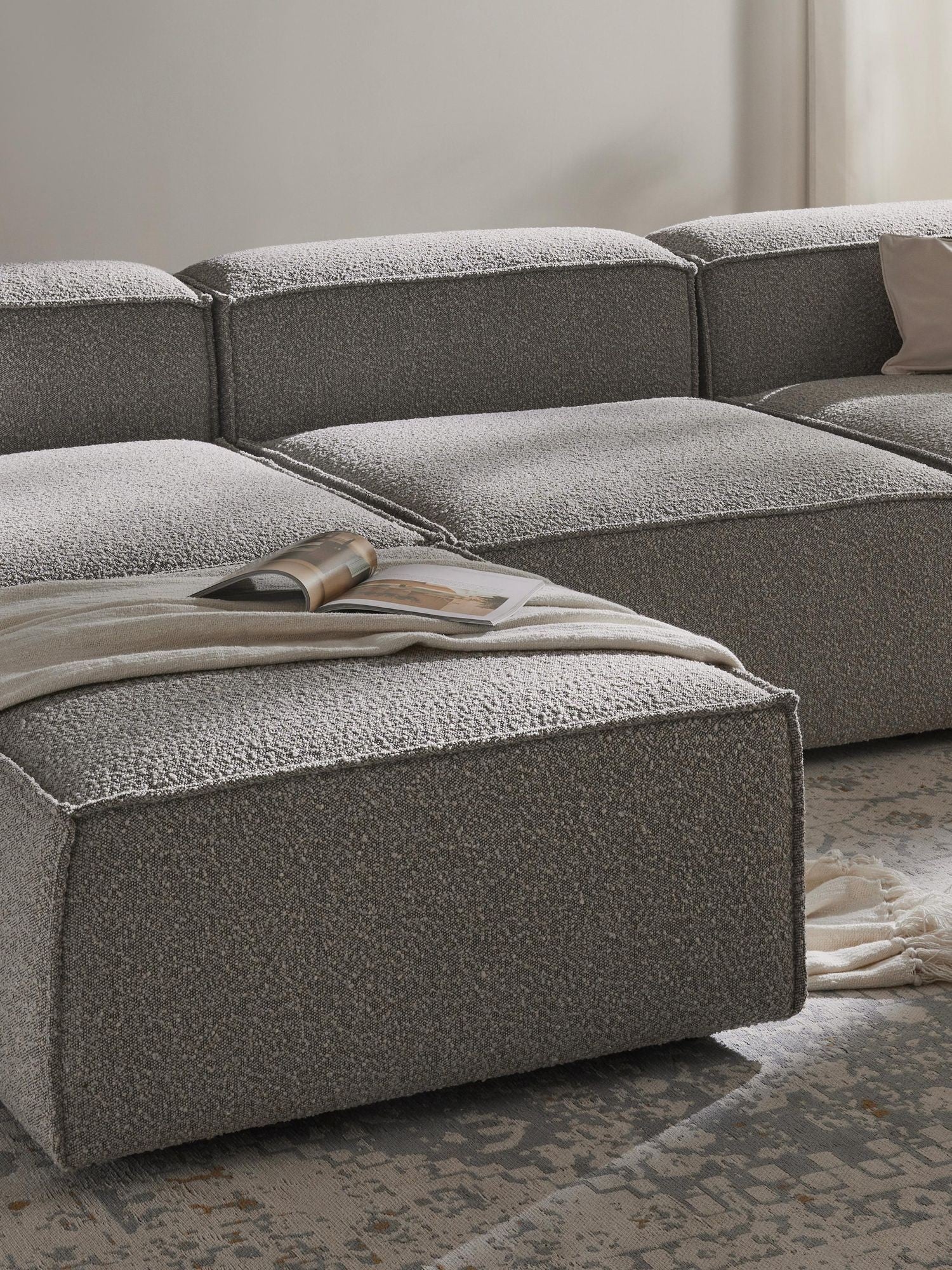 Canapé modulable 4 places en tissu bouclé avec pouf Frida