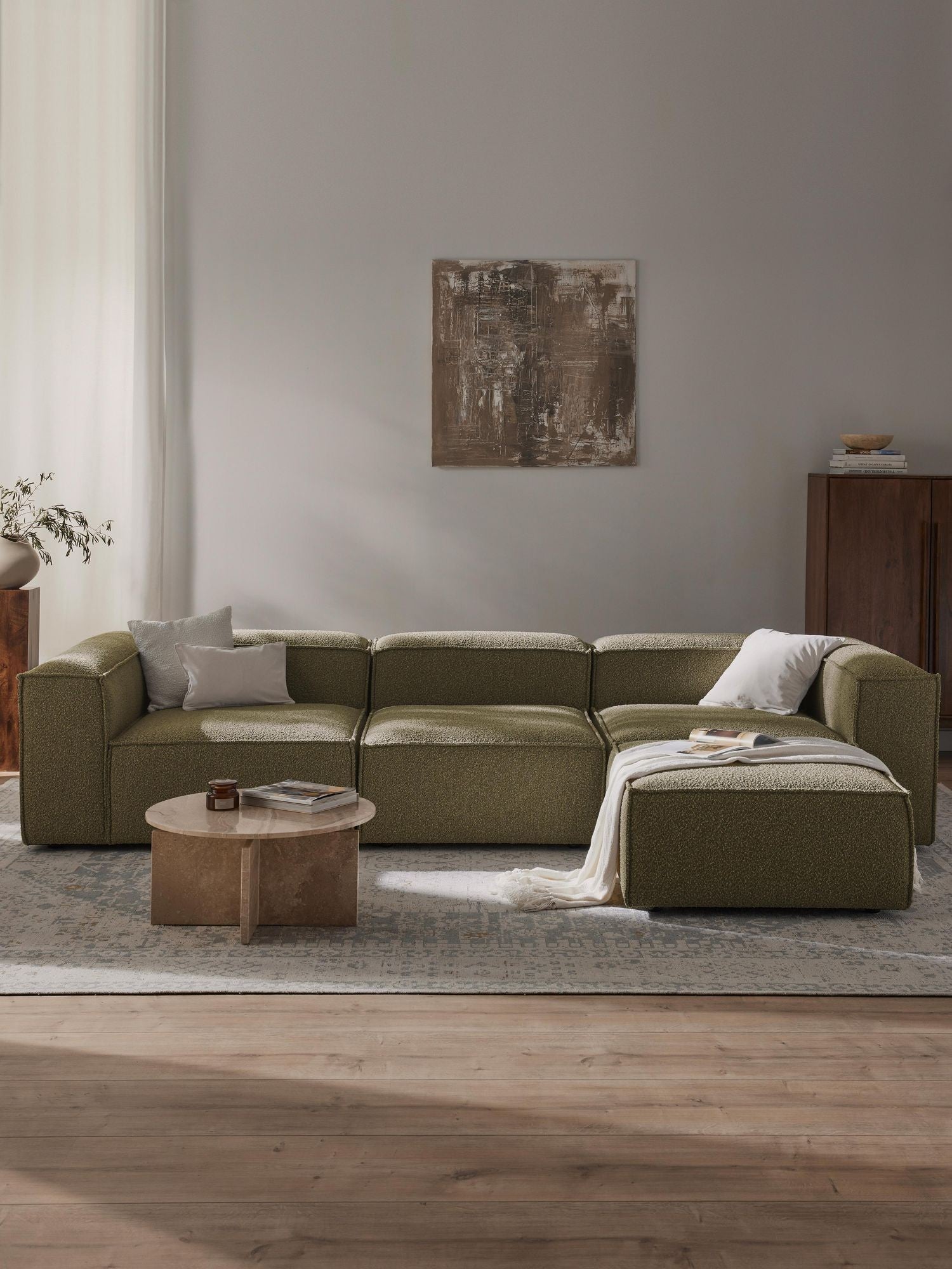 Canapé modulable 4 places en tissu bouclé avec pouf Frida