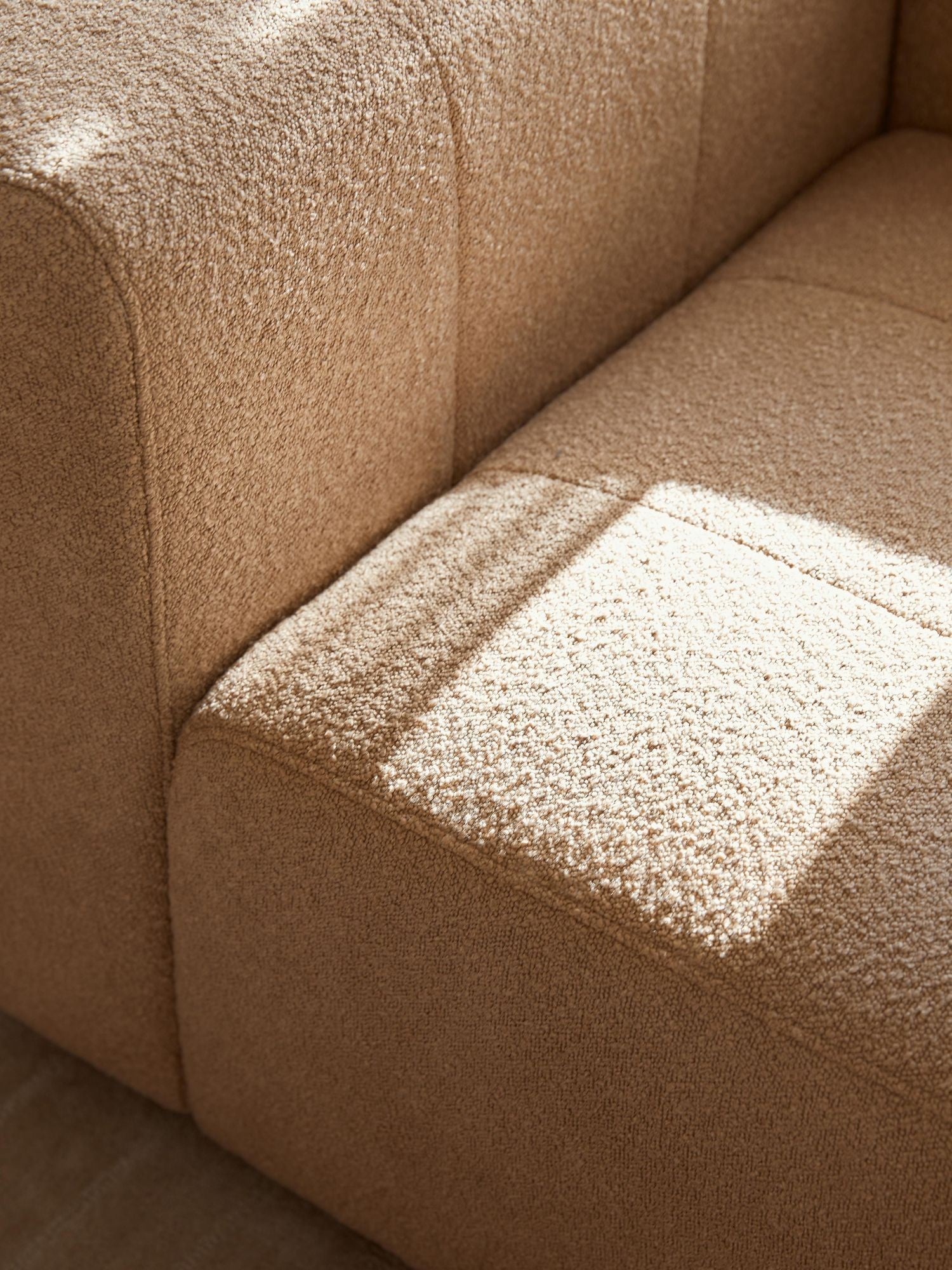 Canapé modulable 4 places en tissu bouclé avec pouf Pietro